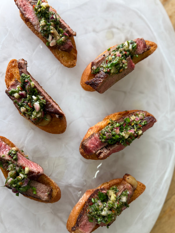 Grilled Beef, Onion Puree, Chimichurri on a Crostini