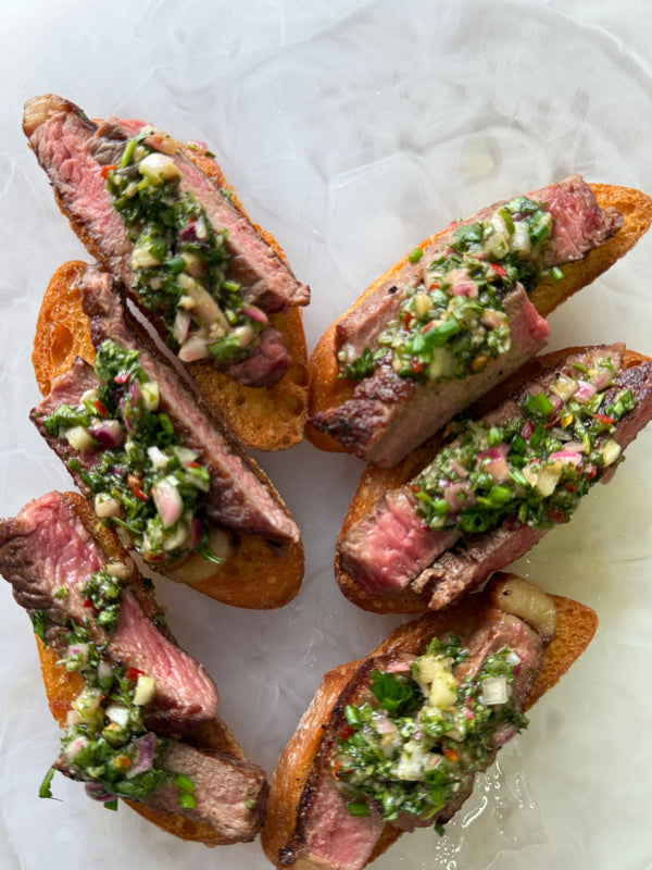 Grilled Beef, Onion Puree, Chimichurri on a Crostini