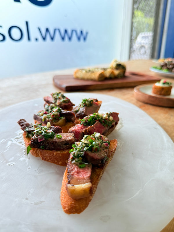 Grilled Beef, Onion Puree, Chimichurri on a Crostini
